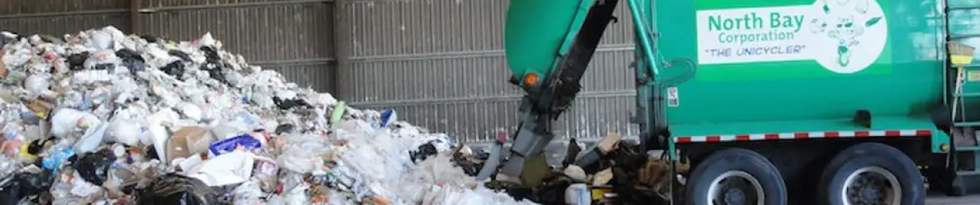 Image of trash near a trash bin with wheels